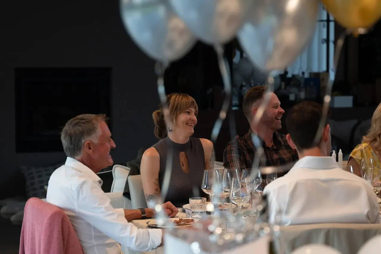 Guests enjoying a relaxed shared feast around the table