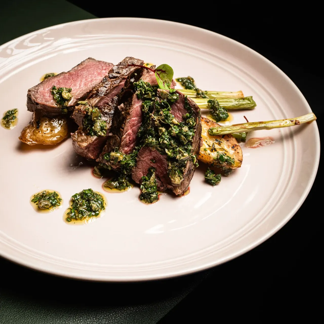 Plated steak with herbs and vegetables