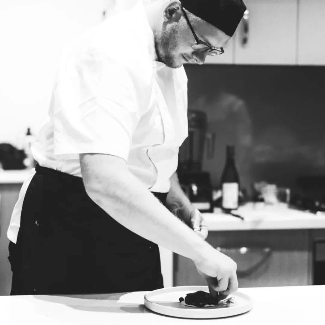 Chef Justin plating a dish during a private dining service